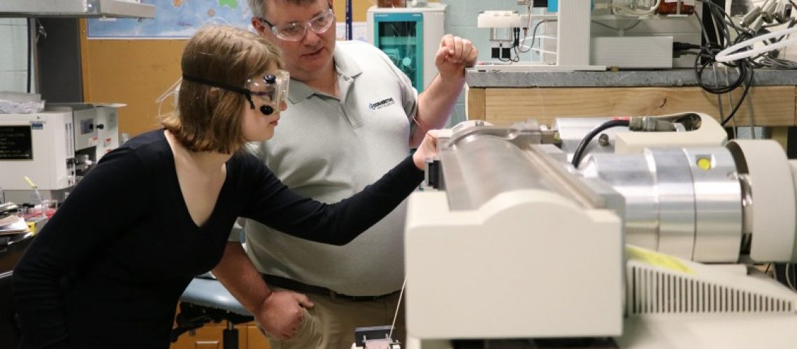 CAL owner and president Mike Goodrich ’92 assists as biochemistry major Madison Davis '19 watches a sample enter the spray chamber of the LC-MS system donated to MC by Adsorptions Systems through this agreement with CAL.